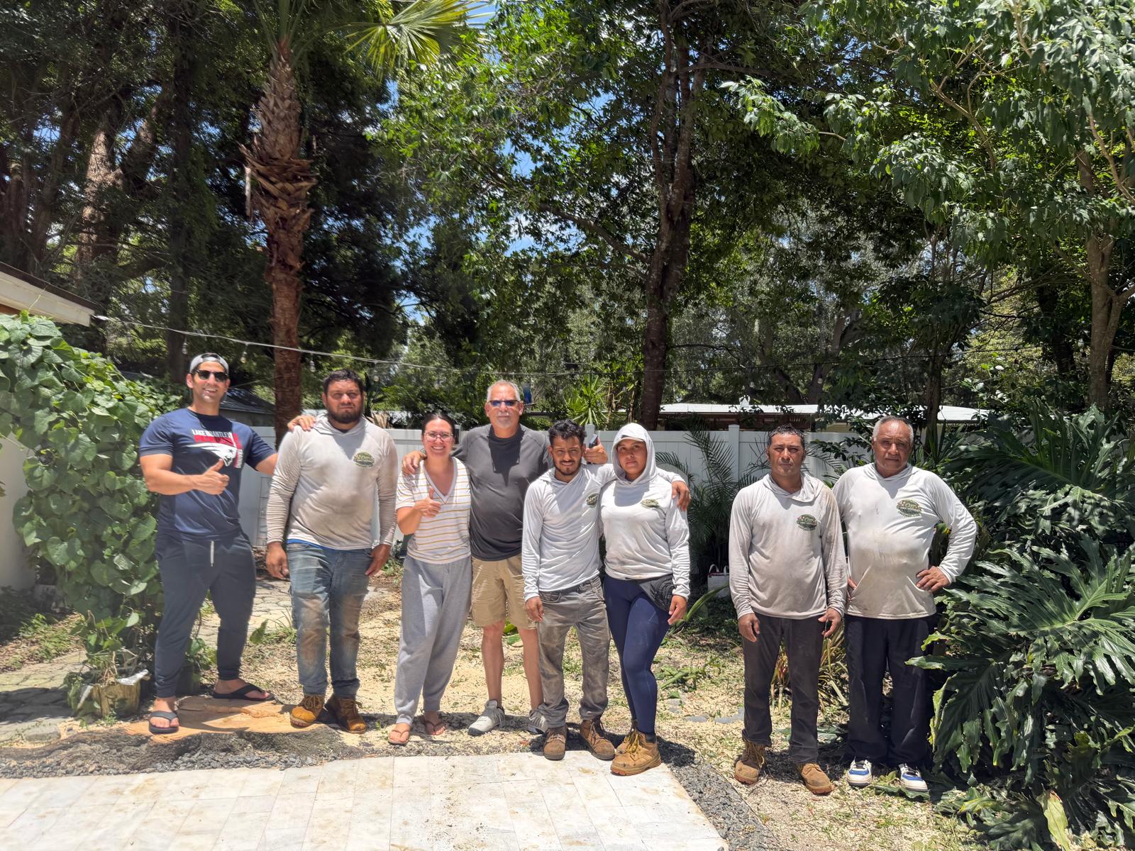 Eight people standing together outdoors